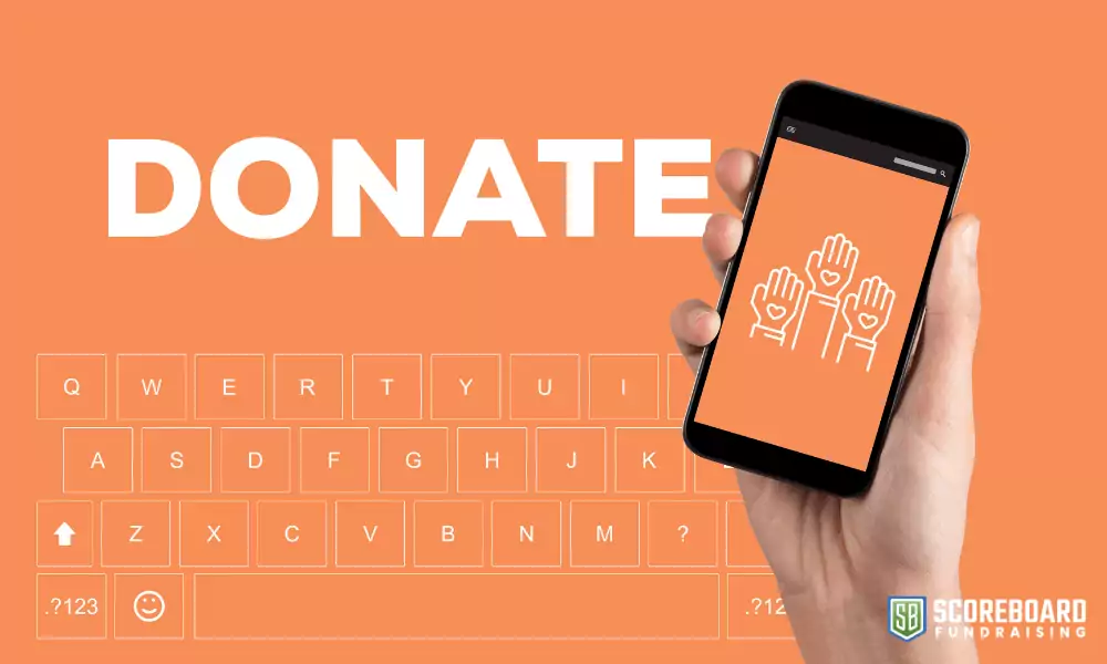 1 The word donate with a hand holding a cell phone.